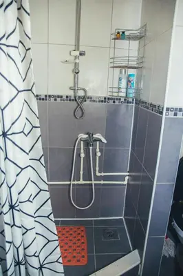 a shower in a bathroom with a shower curtain at Plan B in Niš