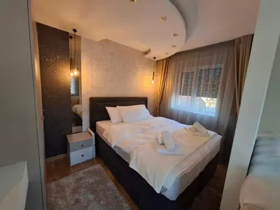 a small bedroom with a bed and a window at Astera 3 in Vrnjci