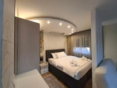 a bedroom with a large bed and a mirror at Astera 3 in Vrnjci