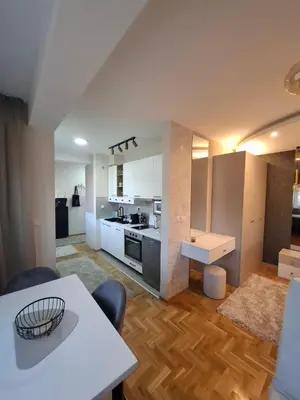 a kitchen and living room with a table and chairs at Astera 3 in Vrnjci