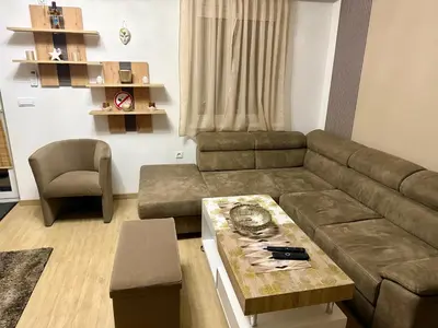 a living room with a couch and a table at Apartman Dolly Vrnjacka banja in Vrnjačka Banja