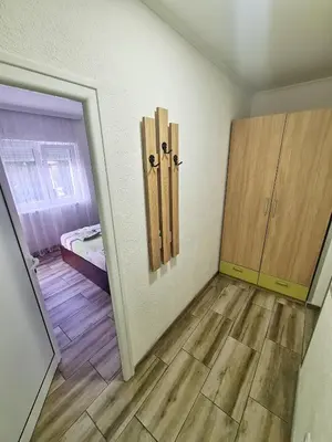 a room with a door and a bedroom with a bed at Vila Aleksandra 2 Apartman 6 in Soko Banja