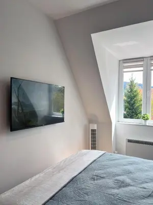 a bedroom with a flat screen tv on the wall at Oaza Kopaonik in Kopaonik