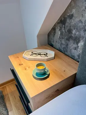 a table with a cup of tea and glasses on it at Oaza Kopaonik in Kopaonik