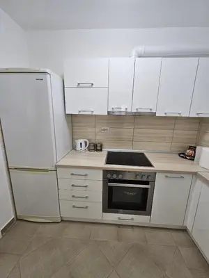 a kitchen with white cabinets and a stove top oven at Anastasija Lux 2 in Paraćin