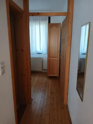 an empty hallway with a door and a window at Kuća za odmor in Bukorovac
