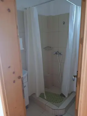 a bathroom with a shower with a shower curtain at Kuća za odmor in Bukorovac