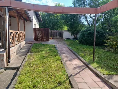 a garden with a walkway in front of a house at Kuća za odmor in Bukorovac