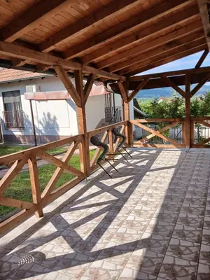 a wooden pergola with a view of a house at Kuća za odmor in Bukorovac