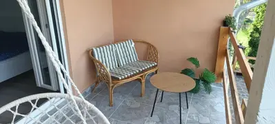 a room with a chair and a table at Vila Piramida - Zavojsko jezero-Pirot in Bukorovac