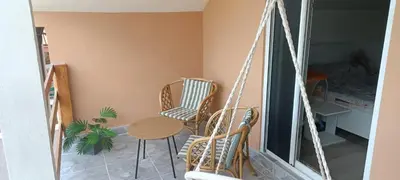 a room with two chairs and a table and a swing at Vila Piramida - Zavojsko jezero-Pirot in Bukorovac