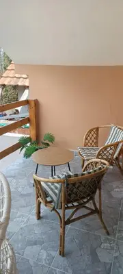 a patio with a table and chairs on a patio at Vila Piramida - Zavojsko jezero-Pirot in Bukorovac