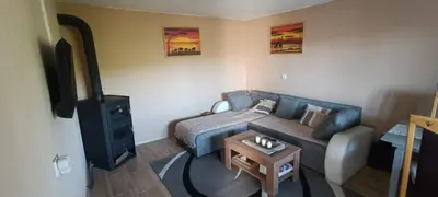 a living room with a couch and a tv at Vila Piramida - Zavojsko jezero-Pirot in Bukorovac
