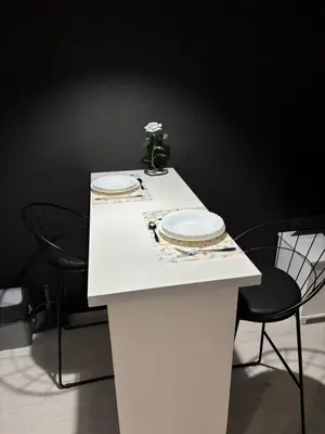 a white table with two plates and two chairs at Apartman Kostić in Niš