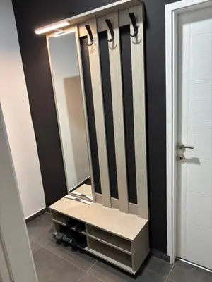 a dressing room with a large mirror on a shelf at Apartman Kostić in Niš
