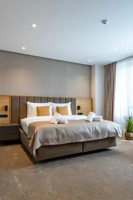a bedroom with a large bed in a room at Hotel Helm in Niš