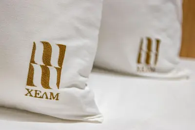 a pair of white shoes with gold lettering on them at Hotel Helm in Niš