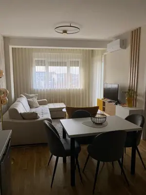 a living room with a couch and a table and chairs at Astera 4 in Vrnjci