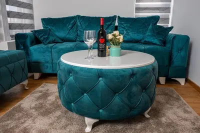 a living room with a couch and a table with wine glasses at Toplina Doma Sokobanja in Soko Banja