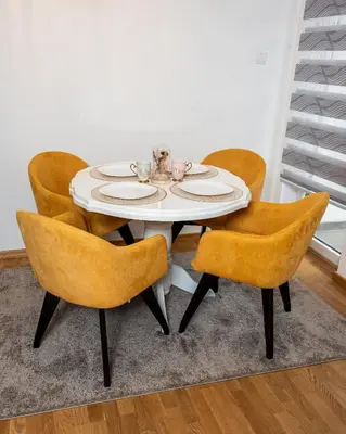a white dining room table with yellow chairs at Toplina Doma Sokobanja in Soko Banja