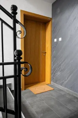 a wooden door with a mat in front of it at Toplina Doma Sokobanja in Soko Banja