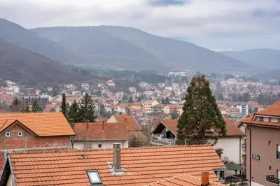 a view of a town with mountains in the background at Toplina Doma Sokobanja in Soko Banja
