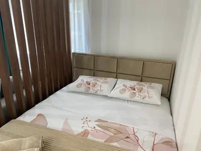 a bed with two pillows on top of it at Apartman MM Vrnjacka Banja in Vrnjci