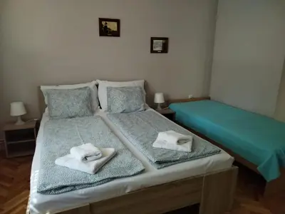 a bedroom with a bed with towels on it at Guest House Dimitrije in Niška Banja