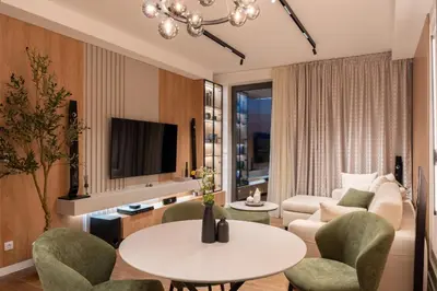 a living room with a couch and a table and chairs at Planet Residence NiNa in Niš