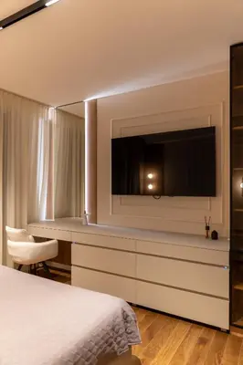 a bedroom with a flat screen tv and a bed at Planet Residence NiNa in Niš