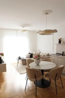 a living room with a table and chairs at Banja Maison in Vrnjačka Banja