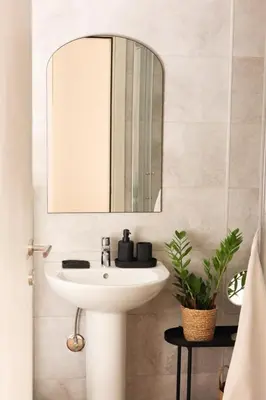 a bathroom with a white sink and a mirror at Banja Maison in Vrnjačka Banja
