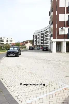 a car parked in a parking lot next to buildings at Banja Maison in Vrnjačka Banja