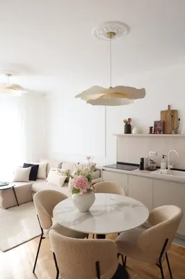 a white living room with a table and chairs at Banja Maison in Vrnjačka Banja