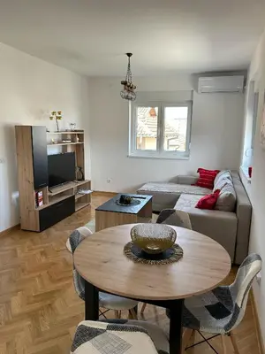 a living room with a table and a couch at Apartman Stević in Vrnjci