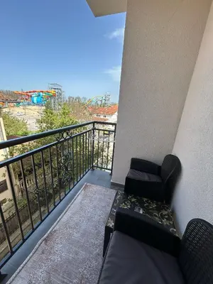 a balcony with a couch and a chair on a balcony at Apartman Stević in Vrnjci