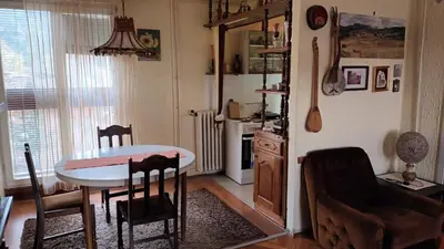 a kitchen and dining room with a table and chairs at Apartman19 Resavica in Železnička Stanica Resavica