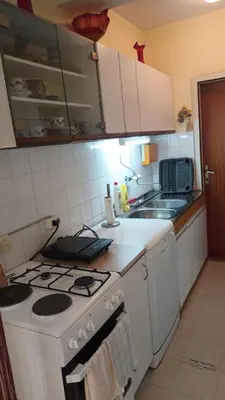 a kitchen with a white stove and a sink at Apartman19 Resavica in Železnička Stanica Resavica