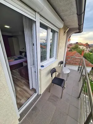 a balcony with a table and chairs and a window at Vila Aleksandra 2 Studio 9 in Soko Banja