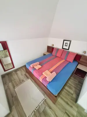 a bedroom with a bed with two towels on it at Vila Aleksandra 2 Studio 16 in Soko Banja