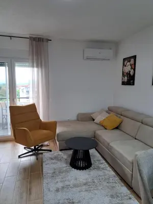 a living room with a couch and a chair at MIL apartment Sokobanja in Soko Banja