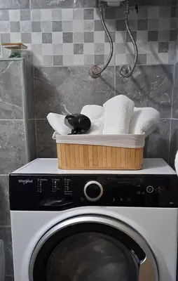 a basket on top of a washing machine at MIL apartment Sokobanja in Soko Banja