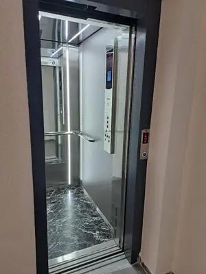 a glass door of a elevator in a building at MIL apartment Sokobanja in Soko Banja