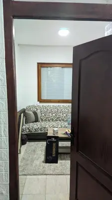 a door leading into a living room with a couch at Mirage Apartments in Niš