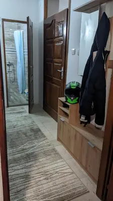 a room with a mirror and a closet at Mirage Apartments in Niš
