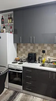a kitchen with a stove and a sink at Mirage Apartments in Niš