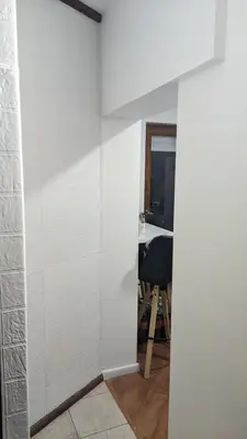 a bathroom with white tile walls and a table at Mirage Apartments in Niš