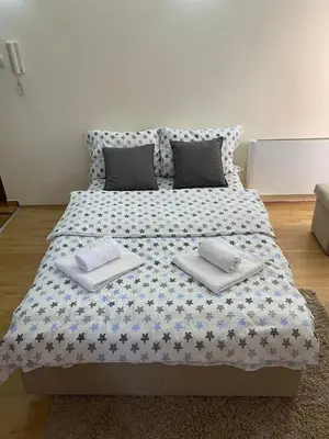 a large bed with pillows on it in a room at Apartman Đalić in Vrnjačka Banja