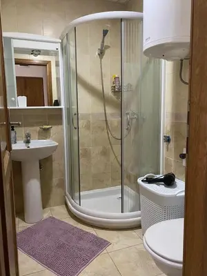 a bathroom with a shower and a toilet and a sink at Apartman Đalić in Vrnjačka Banja