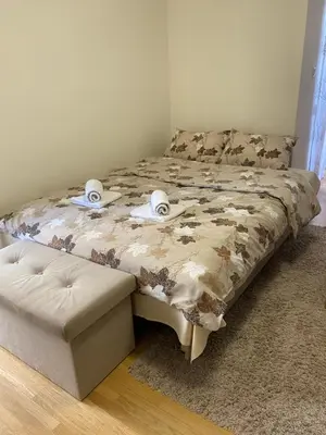 a bedroom with a bed with towels on it at Apartman Đalić in Vrnjačka Banja